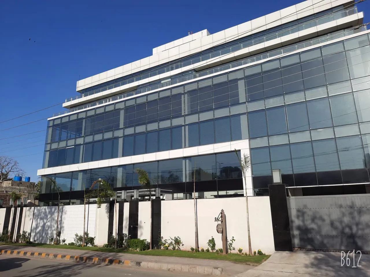 A glazed corporate office in Lahore, filmed floor to floor across the elevation