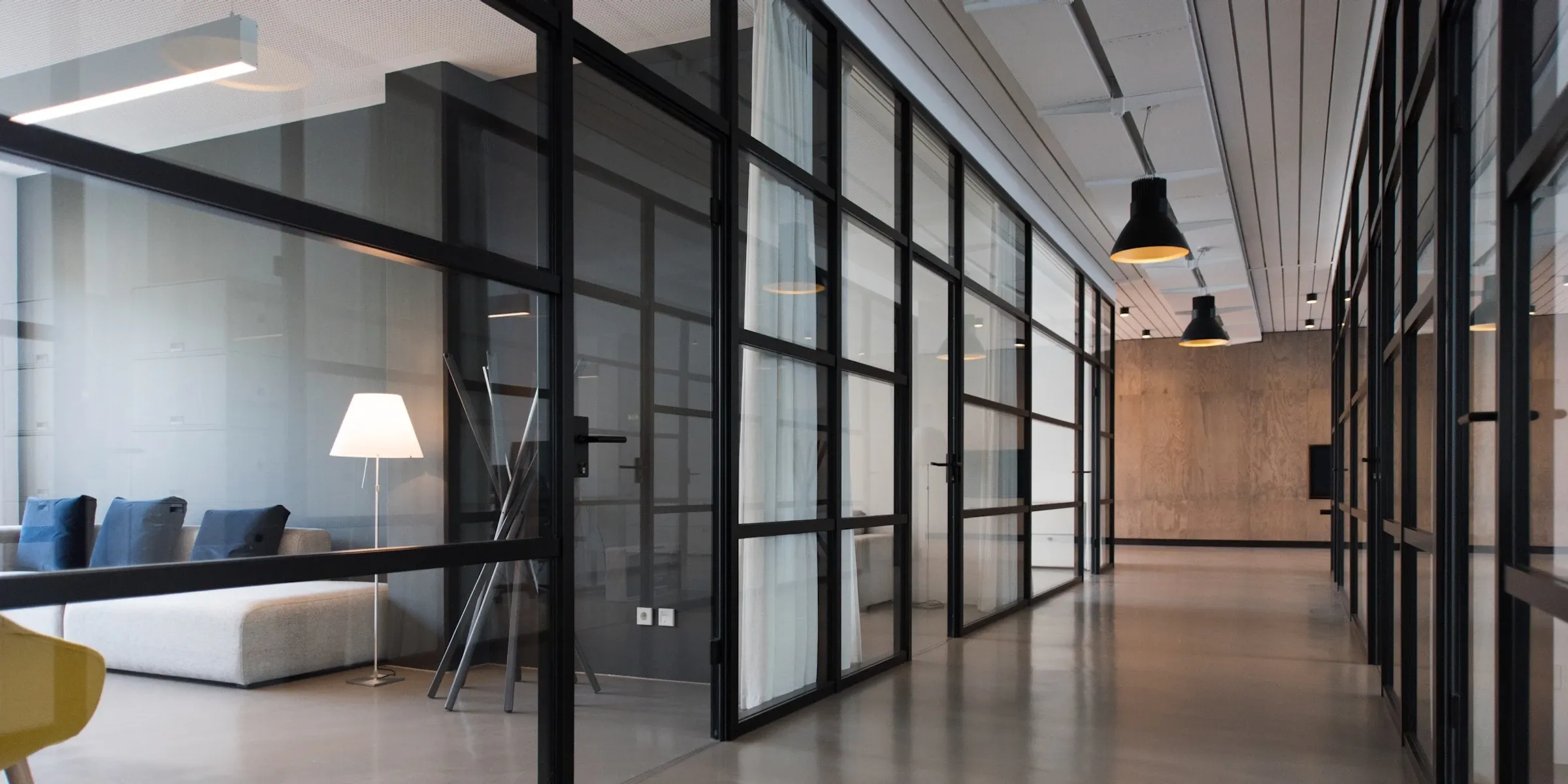 Daylight falling through a wall of glazing into a bright interior